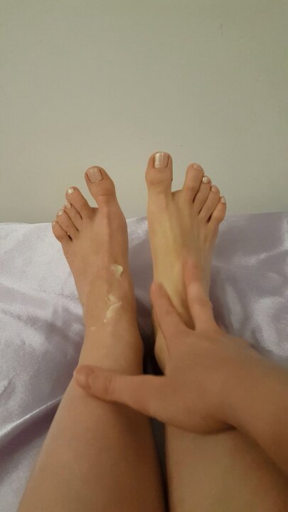 White nail varnish and massage with foot cream